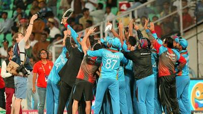 Afghanistan cricketers celebrate after winning their T20 World Cup cricket match against Zimbabwe at the VCA stadium in Nagpur on March 12, 2016. / AFP / Prashant Bhoot
