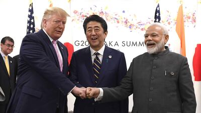 Donald Trump fist bumps Shinzo Abe, Japan's prime minister; and Narendra Modi, India's prime minister during a trilateral meeting at the G20 summit in Osaka, Japan. Bloomberg