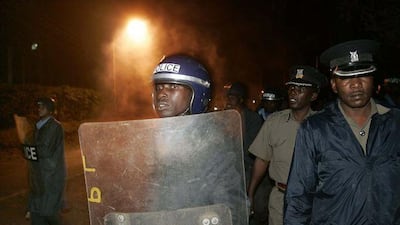 Kenyan riot police walk into clouds of tear gas during running battles with students.