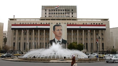 A banner featuring President Bashar Al Assad hangs in the Syrian capital of Damascus. AFP