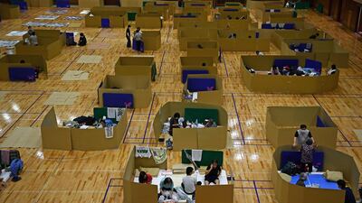 People displaced by floods in Japan's Kumamoto prefecture rest in socially distanced shelters at the Yatsushiro city general gymnasium. AFP
