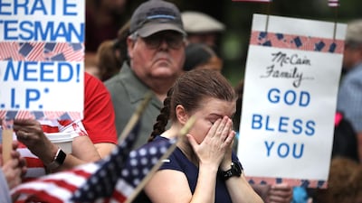 A woman wipes away tears following a wreath laying ceremony to honour the late Senator John McCain. Getty Images / AFP