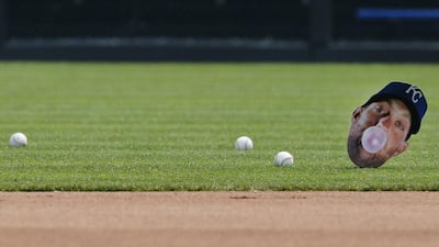 Balls roll next to a photo of Kansas City Royals' Alex Gordon during batting practice before the Royals baseball game against the Minnesota Twins in Kansas City. Teammates taped the photo to a stick and placed it in shallow right field. It was used for target practice. Orlin Wagner / AP Photo