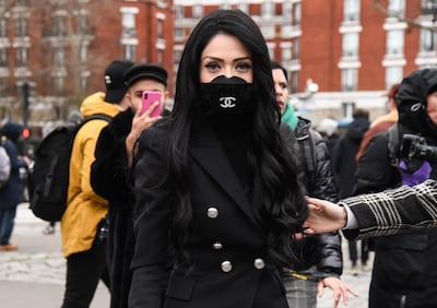 A guest is seen wearing a Chanel mask outside the Balmain show during Paris Fashion Wee. Getty.