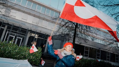 A protester opposed to US annexation of Greenland flies the island’s flag outside the American embassy in Copenhagen, Denmark. AFP