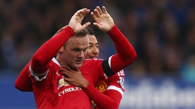 Wayne Rooney holds his hands up after scoring for Manchester United against former club Everton. Clive Brunskill / Getty Images