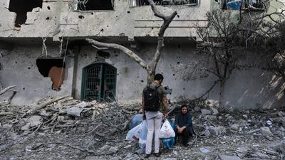 Palestinians in Al Remal neighbourhood, which was destroyed in Israeli air strikes on Gaza. EPA