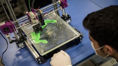 A teacher monitors a 3D printer making parts for face shields amid the Covid-19 outbreak at a Vocational and Technical Anatolian School in Istanbul, Turkey. Getty Images