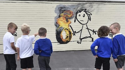 Children from Bridge Farm Primary School look at Banksy authenticated mural. Neil Munns / EPA