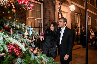 Rishi Sunak, pictured with his wife is Akshata Murty, is hoping political silence over Christmas will quieten worker unrest. Getty Images