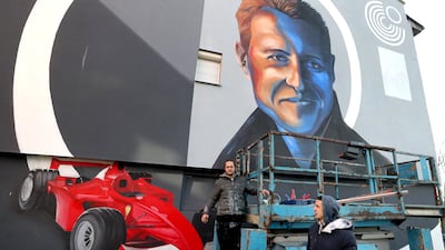 Bosnian artists work on a mural depicting former seven-time Formula One champion Michael Schumacher in Dobrinja, Sarajevo, on Tuesday, January 4, 2022. EPA