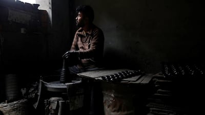 A potter makes earthenware oil lamps or "Diyo" used to decorate temples and homes ahead of Tihar festival, also called Diwali, the Hindu festival of lights, in Bhaktapur, Nepal. Reuters