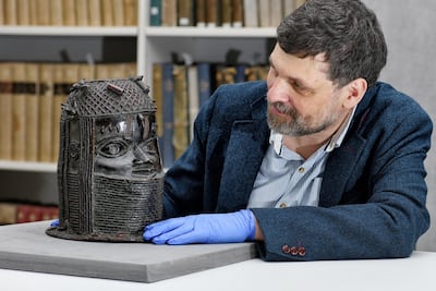 Neil Curtis, head of museums and special collections at the University of Aberdeen, with a Benin bronze set to be returned to Nigeria. University of Aberdeen