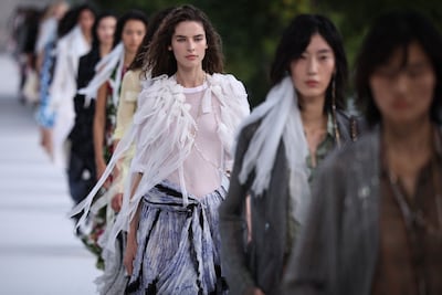Long scarves, cascading earrings and draped fabrics reinforce the collection’s interest in asymmetry. AFP