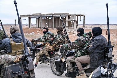 Syrian government fighters outside Deir Hafir, east of Aleppo, on January 17 as the SDF is told to withdraw from the area. Getty Images