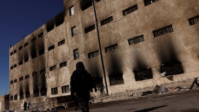 A Syrian woman searches for a relative who was detained in Sednaya prison, which became notorious under Bashar Al Assad's rule. Reuters