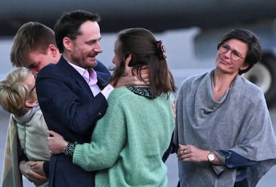 Belgian aid worker Olivier Vandecasteele is welcomed by his family after being freed in a swap with an Iranian diplomat imprisoned in Belgium. Reuters