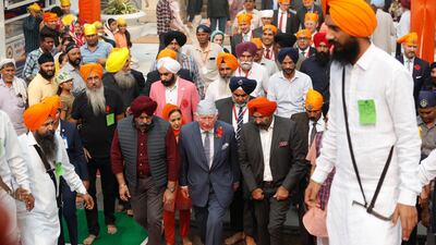 Britain's Prince Charles, centre, arrives at Gurudwara Bangla Sahib, a Sikh Temple in New Delhi, India, Wednesday, Nov. 13, 2019. Prince Charles visited the Sikh temple to participate in celebrations of the 550th birth anniversary of Sikh Guru, Baba Guru Nanak, and mark the contribution of the Sikh community in Britain. During his two day visit he is also meeting with Indian experts focusing on global challenges such as business sustainability and climate change. AP