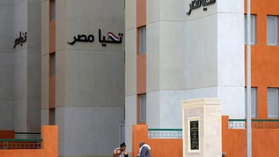 Residents sit in front of their new apartment buildings at the Tahya Misr housing project. Amr Abdallah Dalsh/Reuters