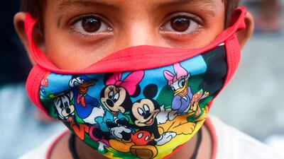 A child wears a face mask depicting Disney characters amid concerns over the spread of the Covid-19 coronavirus, in Kolkata, India. AFP
