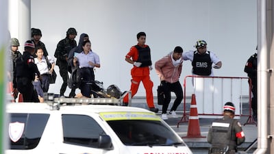 Soldiers evacuate hostages from mass shooting scene at the Terminal 21 shoppibng mall in Nakhon Ratchasima, Thailand. EPA