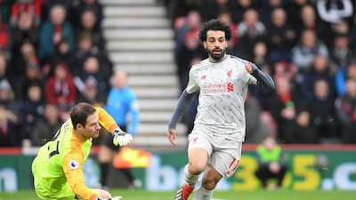 Salah goes past Asmir Begovic and goes onto to score his hat-trick and his side's fouth goal against Bournemouth. Getty Images