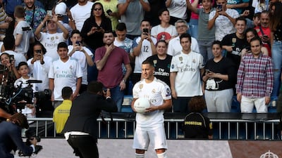 Eden Hazard poses for photos in front of fans. Reuters
