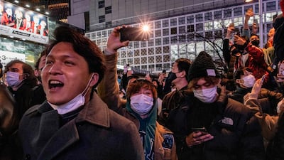 People chant as they celebrate New Year's day in Shibuya district of Tokyo. AFP