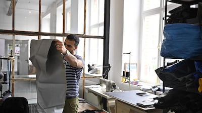 The fabric from rubber dinghies is transformed by refugees into different sorts of bags, sold online. AFP