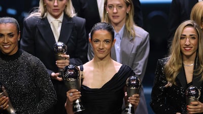 Spain and Barcelona midfielder Aitana Bonmati poses with her awards as she was also named in the Best XI women's team. AP