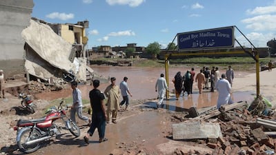 Pakistani residents cross a damaged bridge following flooding in Islamabad on September 6, 2014. Farooq Naeem/AFP Photo