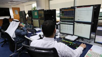 Employees working in the trading room at the National Bank of Fujairah office in Bur Dubai in Dubai. Pawan Singh / The National
