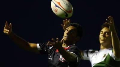 A Dubai College player, in blue, wins the ball during their Dubai Schools final against Jumeirah College. The game ended up being very close. Satish Kumar / The National