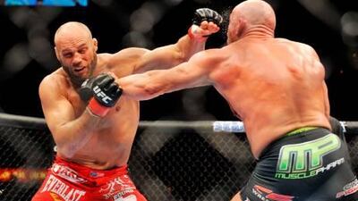 Randy Couture, left, slugs it out with Mark Coleman in a 2006 UFC light heavyweight bout in Las Vegas before he retired to Hollywood. Jon Kopaloff / Getty Images