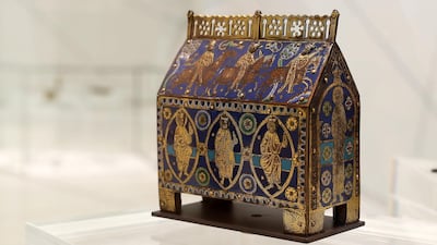 Reliquary casket with the Three Magi, Limoges, France (c.1200): This intricately crafted reliquary casket from the 13th century, which would have housed fragments of bone or clothing belonging to a Christian saint, sits alongside an urn from Italy (600 BCE) and a portable temple from Fiji (before 1900). Christian pilgrims would travel many miles to see a reliquary casket such as this one, which depicts scenes from the New Testament story of the Three Kings. The vibrant blue and gold casket is designed using a technique called champlevé, which involves carving shapes into a metal surface, filling them with coloured enamel or powdered glass and then heating the metal until the substances fuse. Photo: Pawan Singh / The National