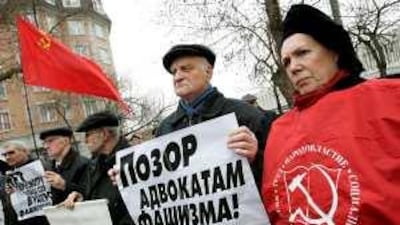 Displaying communist symbols, such as the Soviet flag during this 2007 protest against delaying the opening of a museum exhibit on the Auschwitz death camp, has been criminalised under Polish law.