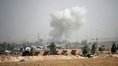 Smoke rises from clashes between Iraqi security forces and ISIL militants in Fallujah. Thaier Al Sudani / Reuters