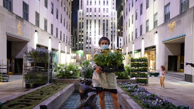 Egyptian-French artist Ghada Amer standing in front of her work, 'Women's Qualities' (2020), at Rockefeller Centre. Photo courtesy Casey Kelbaugh / Frieze