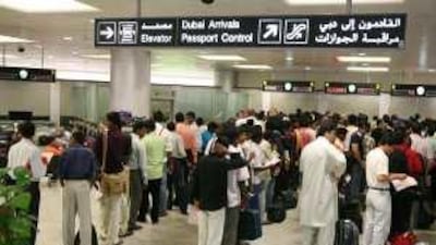 Men queue to have their eyes scanned at Dubai International Airport.