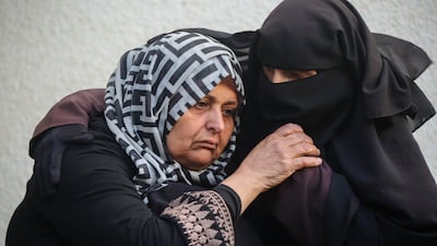 Mourners wait to collect the bodies of relatives killed in an airstrike on January 12, in Rafah. Getty Images