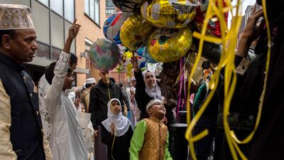 Children choose balloons outside the East London Mosque after morning prayers during Eid celebrations in London in May. Getty Images