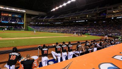 Miami Marlins players look on from the dugout, all wearing wearing Jose Fernandez jerseys and his name and number 16. The Marlins officially retired the number in honour of the late pitcher. Rob Foldy/Getty Images