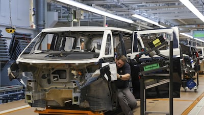 Manufacturing workers assemble a Volkswagen electric vehicle at a plant in Hannover, Germany. Bloomberg