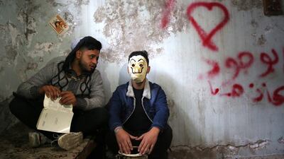 Members of After Dark group, 22-year-old, left, Hakam Akram and 19-year-old Ahmad Al Abbasi perform at their studio in Mosul, northern Iraq. The band was founded by a group of young men in Mosul city. It performs theatrical performances to support Iraqi social issues and protests. EPA