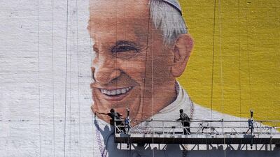 Two men paint a mural of Pope Francis on the wall of a high-rise building in New York. Pope Francis will visit the US on September 22-27, stopping in Washington, DC, New York, and Philadelphia. Jewel Samad / AFP Photo