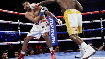 Terence Crawford, right, punches England's Amir Khan during the fifth round. AP Photo