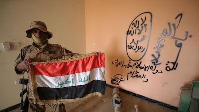 From graffiti on the walls of buildings in Iraq to an app for children, ISIL has misappropriated the Arabic language. Haidar Mohammed Ali / AFP