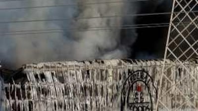 A thick cloud of smoke billows as firefighters battle a blaze at the warehouse of Federal Foods in the Al Quoz Industrial Area last week.
