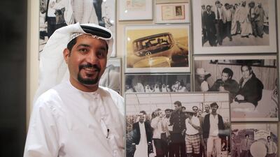 Ali Kaddas Al Romaithi with framed photos hanging on his wall of Muhammad Ali’s first visit to Abu Dhabi. Ravindranath K / The National