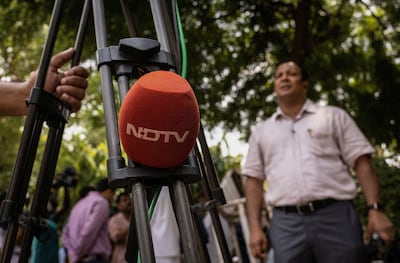 A microphone of New Delhi Television is placed on a tripod along a roadside in New Delhi. Reuters